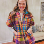Short sleeved zip front sherpa jacket in bold orange, purple, pink and blue plaid with pockets.