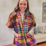Short sleeved zip front sherpa jacket in bold orange, purple, pink and blue plaid with pockets.