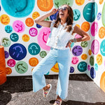 A crisp white twill vest that's equal parts polished and playful—those ruffled sleeves are the kind of detail that makes every outfit feel intentional. Button-down front, collar, and functional pockets.