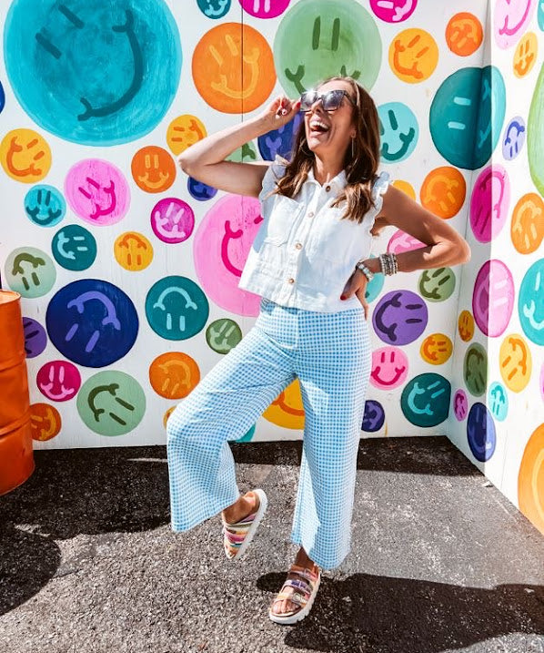 A crisp white twill vest that's equal parts polished and playful—those ruffled sleeves are the kind of detail that makes every outfit feel intentional. Button-down front, collar, and functional pockets.