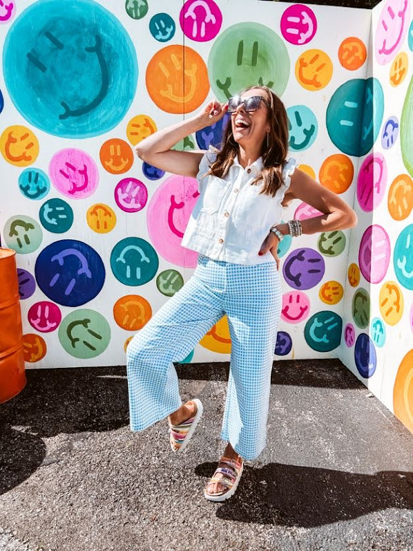 A crisp white twill vest that's equal parts polished and playful—those ruffled sleeves are the kind of detail that makes every outfit feel intentional. Button-down front, collar, and functional pockets.