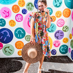 This tropical print short dress features vibrant summer hues with playful striping and fruit motifs throughout, square smocked neckline and flutter sleeves and pockets—complete with pink and blue ball tassels. Crafted from soft, lightweight fabric, it's designed to move with you all day long.