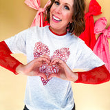Light grey heathered tee with a pink and red heart made of bows on the front.