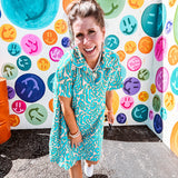 Teal and tan patterned mini dress with 1/4 button front and collar with short sleeves and pockets, fully lined.