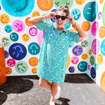 Teal and tan patterned mini dress with 1/4 button front and collar with short sleeves and pockets, fully lined.