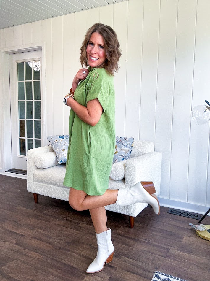 Chartreuse gauze mini dress with collar and V neck with cutout floral embroidery at the shoulders, cuffed sleeves and pockets.