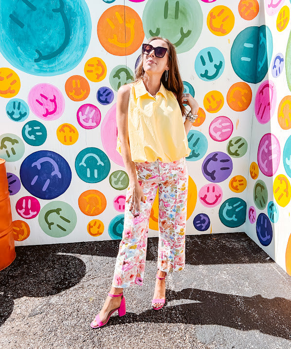 Buttery yellow sleeveless collared tank with V-neck design and structured collar and fully lined bodice and bubble hem.