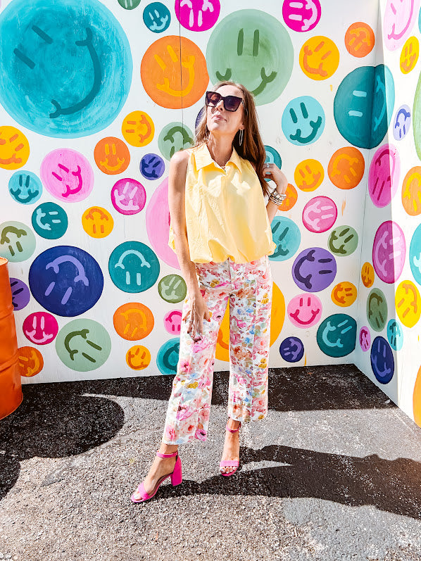 Buttery yellow sleeveless collared tank with V-neck design and structured collar and fully lined bodice and bubble hem.