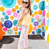 Buttery yellow sleeveless collared tank with V-neck design and structured collar and fully lined bodice and bubble hem.