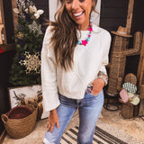 Ivory cable knit cropped sweater.