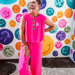 Fuchsia set including a bubble hem, sleeveless blouse with pleated shoulders and wide-leg pants with pockets.