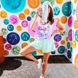 Cool pink cotton sleeveless tee with a shorter hemline with "Be Salty Stay Lit" multi colored retro inspired graphic on the front.
