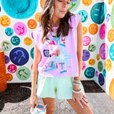 Cool pink cotton sleeveless tee with a shorter hemline with "Be Salty Stay Lit" multi colored retro inspired graphic on the front.