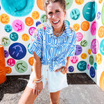 White shorts with lining and textured outer layer with elastic drawstring waist with wooden ends on the ties.