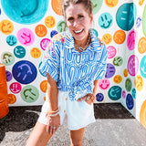 White shorts with lining and textured outer layer with elastic drawstring waist with wooden ends on the ties.
