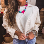 Ivory cable knit cropped sweater.