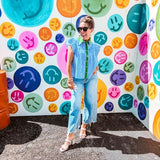 Lightweight cotton blue and white striped flutter sleeve top with button down front and green trim at the collar and placket.