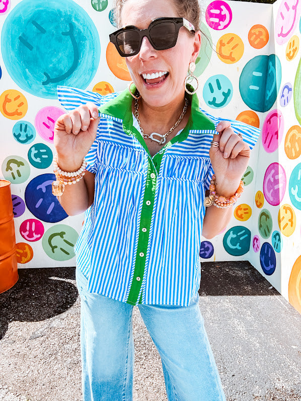 Lightweight cotton blue and white striped flutter sleeve top with button down front and green trim at the collar and placket.