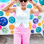 Soft, chic white button vest with gold shell and sun faux buttons down the front and a peekaboo front hem, round neck.