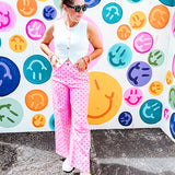 Warm pink lightweight button and zipper closure wide leg pants with red polka dots throughout with side and back pockets.
