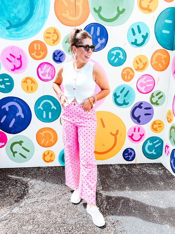 Warm pink lightweight button and zipper closure wide leg pants with red polka dots throughout with side and back pockets.