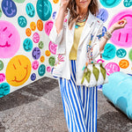 Cream fitted blazer with vibrant floral embroidery and French embroidered —"j'taime," "amour," "bisou, bisou"—with structured shoulder padding and scrunched sleeves.