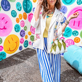 Cream fitted blazer with vibrant floral embroidery and French embroidered —"j'taime," "amour," "bisou, bisou"—with structured shoulder padding and scrunched sleeves.