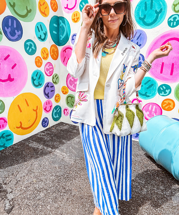 Cream fitted blazer with vibrant floral embroidery and French embroidered —"j'taime," "amour," "bisou, bisou"—with structured shoulder padding and scrunched sleeves.