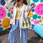 Cream fitted blazer with vibrant floral embroidery and French embroidered —"j'taime," "amour," "bisou, bisou"—with structured shoulder padding and scrunched sleeves.