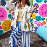 Cream fitted blazer with vibrant floral embroidery and French embroidered —"j'taime," "amour," "bisou, bisou"—with structured shoulder padding and scrunched sleeves.