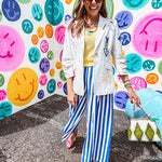 Cream fitted blazer with vibrant floral embroidery and French embroidered —"j'taime," "amour," "bisou, bisou"—with structured shoulder padding and scrunched sleeves.