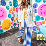 Cream fitted blazer with vibrant floral embroidery and French embroidered —"j'taime," "amour," "bisou, bisou"—with structured shoulder padding and scrunched sleeves.