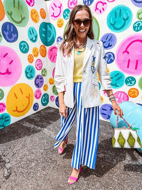 Cream fitted blazer with vibrant floral embroidery and French embroidered —"j'taime," "amour," "bisou, bisou"—with structured shoulder padding and scrunched sleeves.