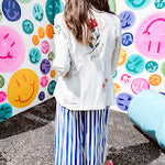 Cream fitted blazer with vibrant floral embroidery and French embroidered —"j'taime," "amour," "bisou, bisou"—with structured shoulder padding and scrunched sleeves.