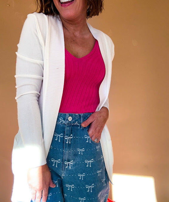 Lightweight, open front cardigan with wide ribbed trim and cuffs and pockets.