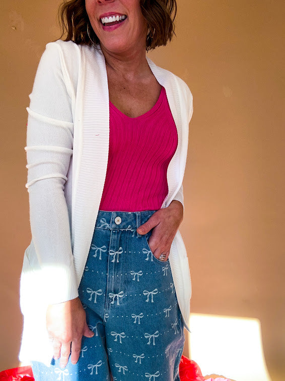 Lightweight, open front cardigan with wide ribbed trim and cuffs and pockets.