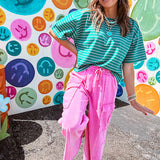 Cotton terry wide leg pants in mineral washed bubble gum pink with elastic drawstring waist, oversized pockets and raw seams.
