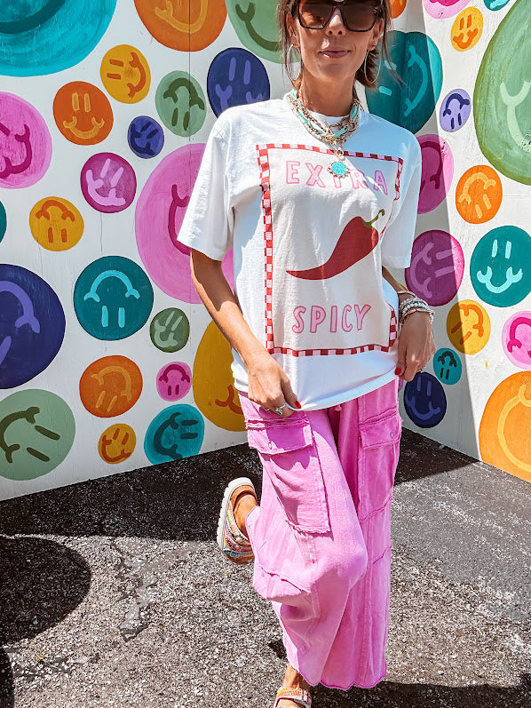 Washed white tee with pink and red checkered graphic paired with a fiery pepper design.