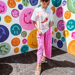 Washed white tee with pink and red checkered graphic paired with a fiery pepper design.