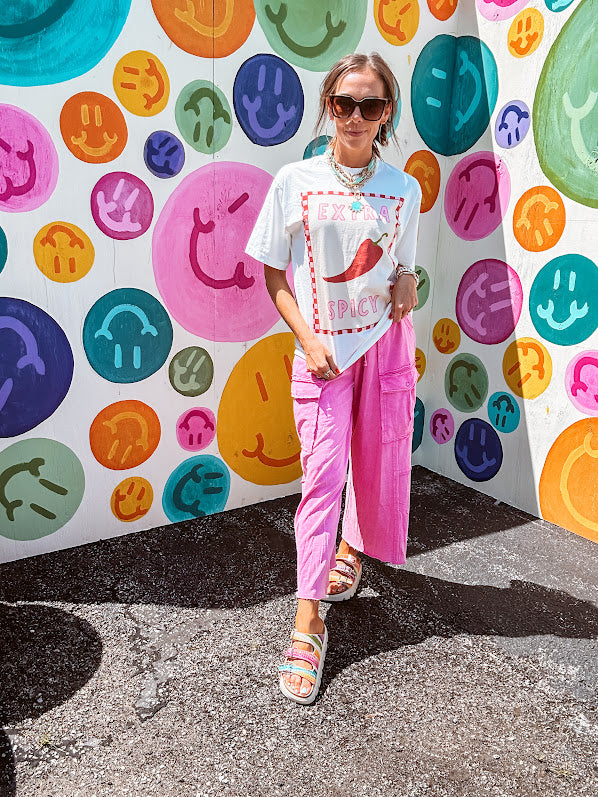 Washed white tee with pink and red checkered graphic paired with a fiery pepper design.