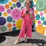 Soft, stretchy ribbed textured set in pink and red checkers with an oversized short sleeved round neck top and matching elastic waist, wide leg bottoms.