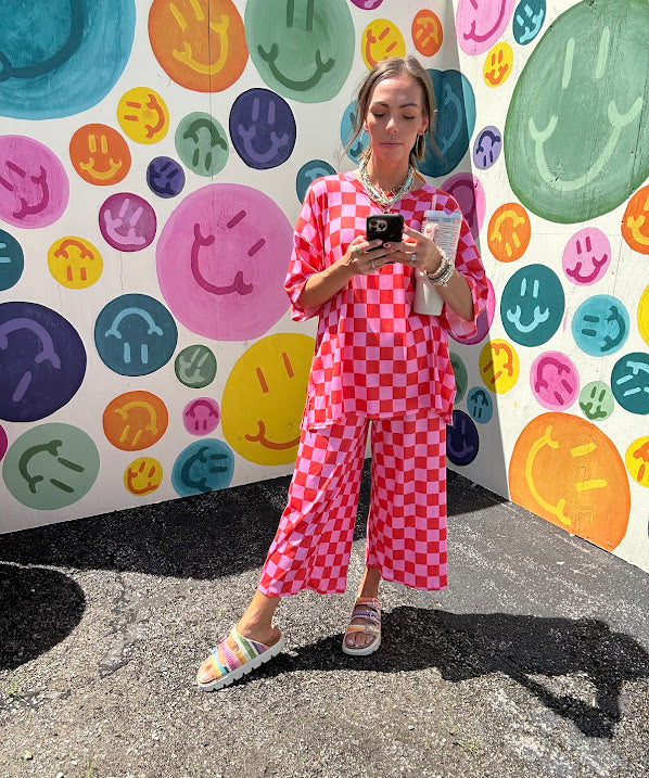 Soft, stretchy ribbed textured set in pink and red checkers with an oversized short sleeved round neck top and matching elastic waist, wide leg bottoms.