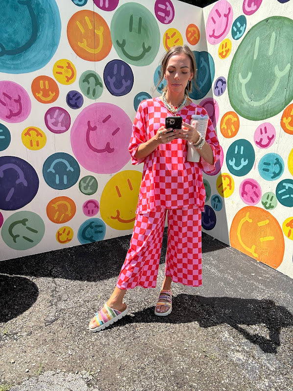Soft, stretchy ribbed textured set in pink and red checkers with an oversized short sleeved round neck top and matching elastic waist, wide leg bottoms.