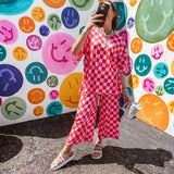 Soft, stretchy ribbed textured set in pink and red checkers with an oversized short sleeved round neck top and matching elastic waist, wide leg bottoms.