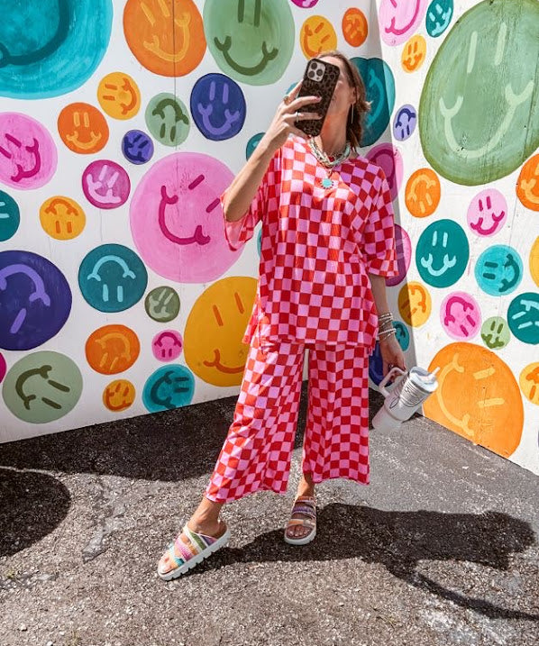 Soft, stretchy ribbed textured set in pink and red checkers with an oversized short sleeved round neck top and matching elastic waist, wide leg bottoms.
