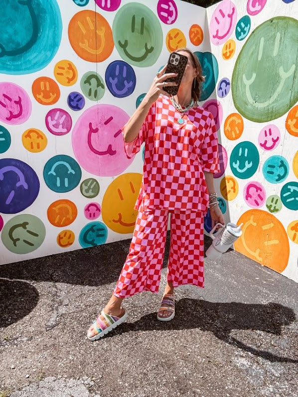 Soft, stretchy ribbed textured set in pink and red checkers with an oversized short sleeved round neck top and matching elastic waist, wide leg bottoms.