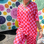 Soft, stretchy ribbed textured set in pink and red checkers with an oversized short sleeved round neck top and matching elastic waist, wide leg bottoms.