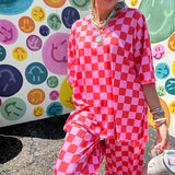 Soft, stretchy ribbed textured set in pink and red checkers with an oversized short sleeved round neck top and matching elastic waist, wide leg bottoms.