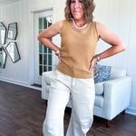 Soft waffle textured knit tank top with round neck and wide hem.