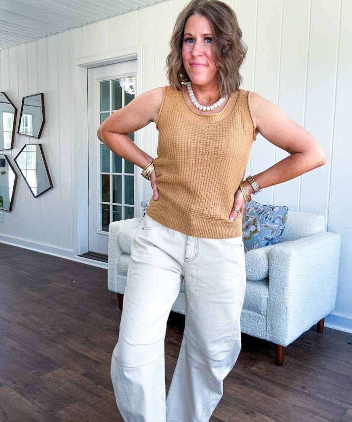 Soft waffle textured knit tank top with round neck and wide hem.